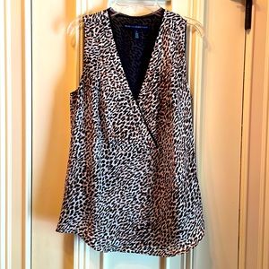 Sleeveless polyester silk sheer animal print top lined in black.